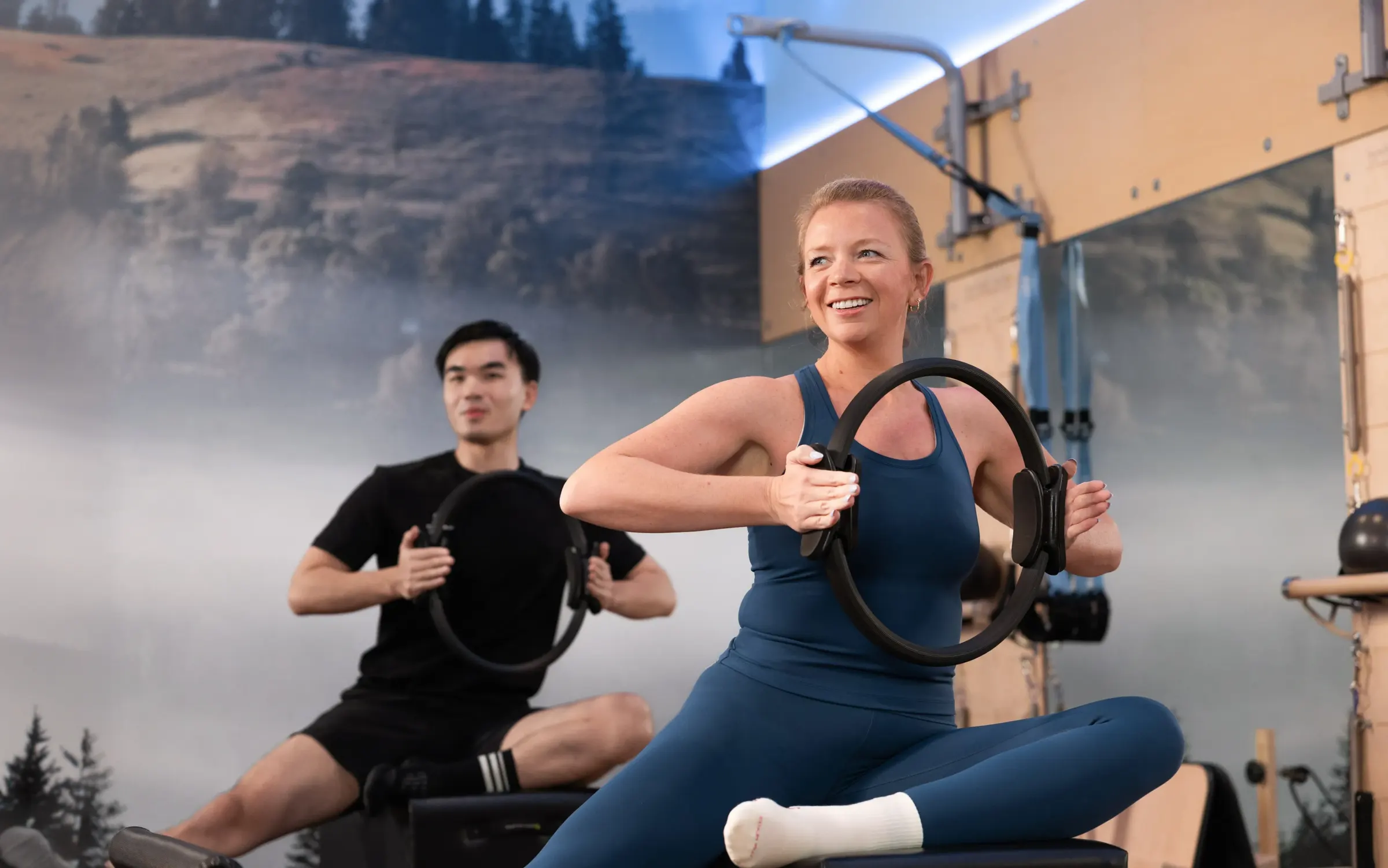 Member using a Pilates ring in class