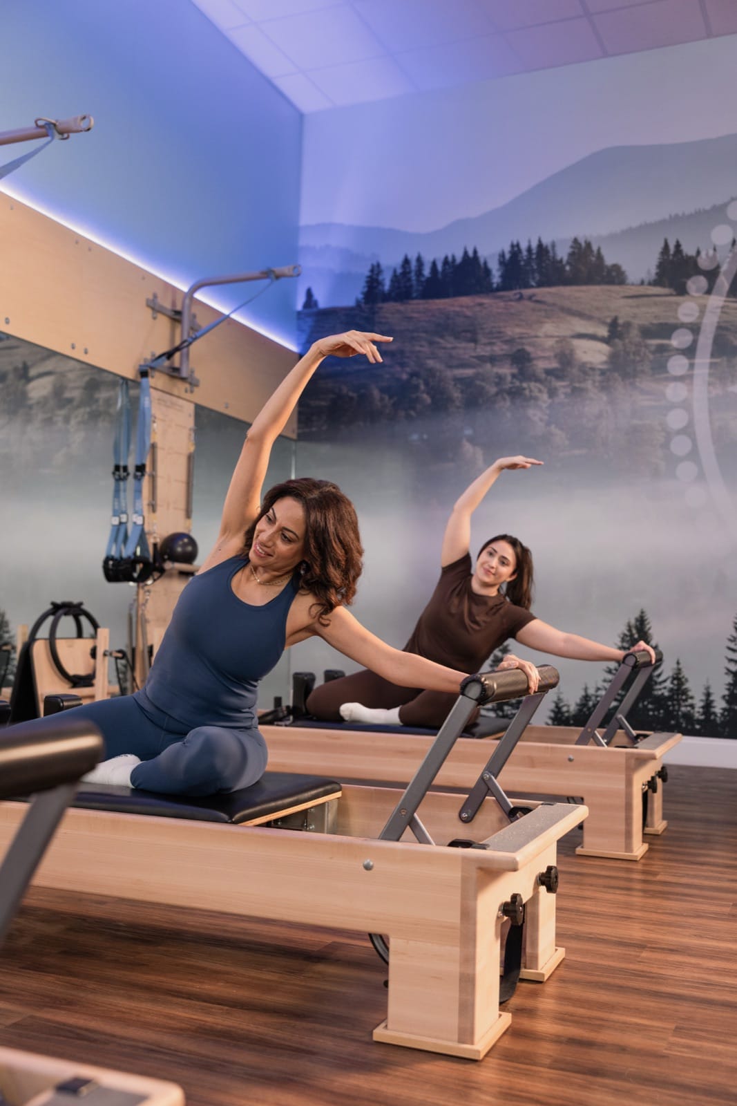 Members stretching side to side on the Reformer